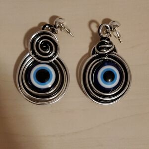 Pair of Earrings featuring Evil Eye Protection  in Silver Swirls